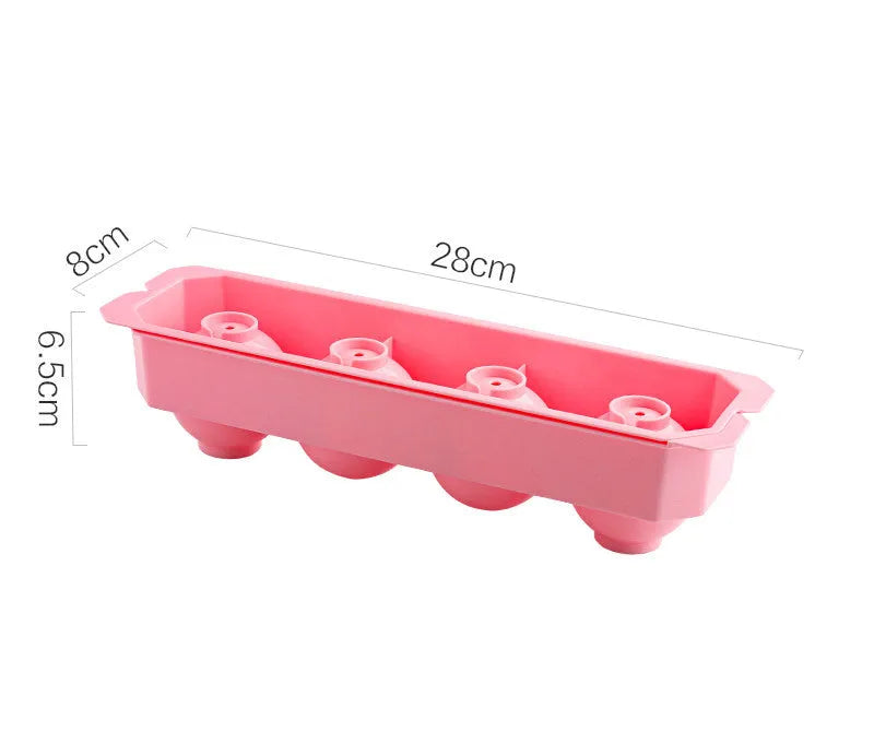 Flexible silicone ice tray producing large ice spheres, hockey puck shapes, and pentagon ice on a kitchen counter.
