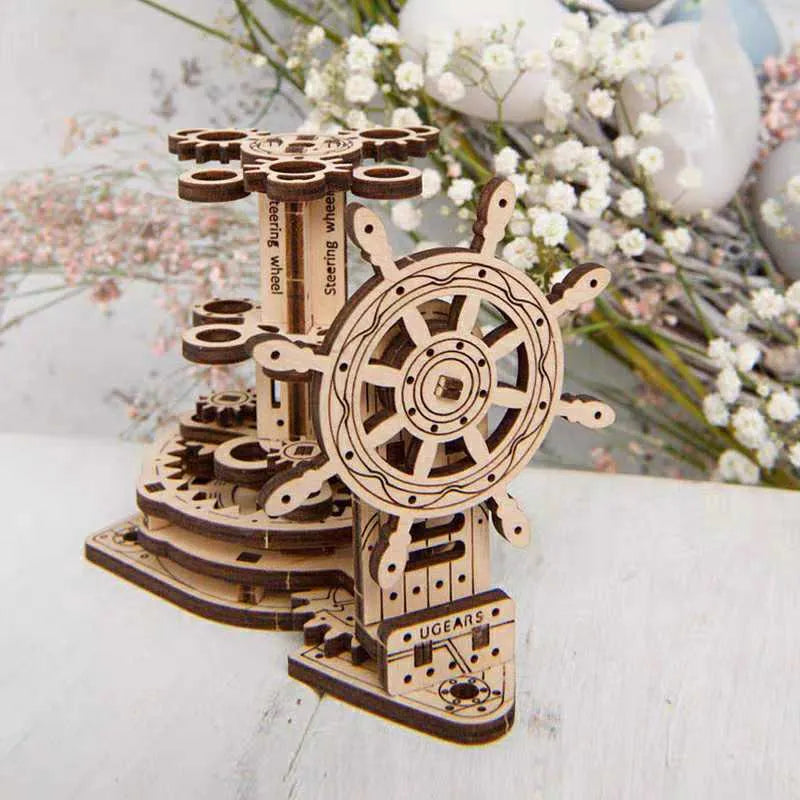 Wooden steering wheel model that rotates and functions as a pen holder on a desk.