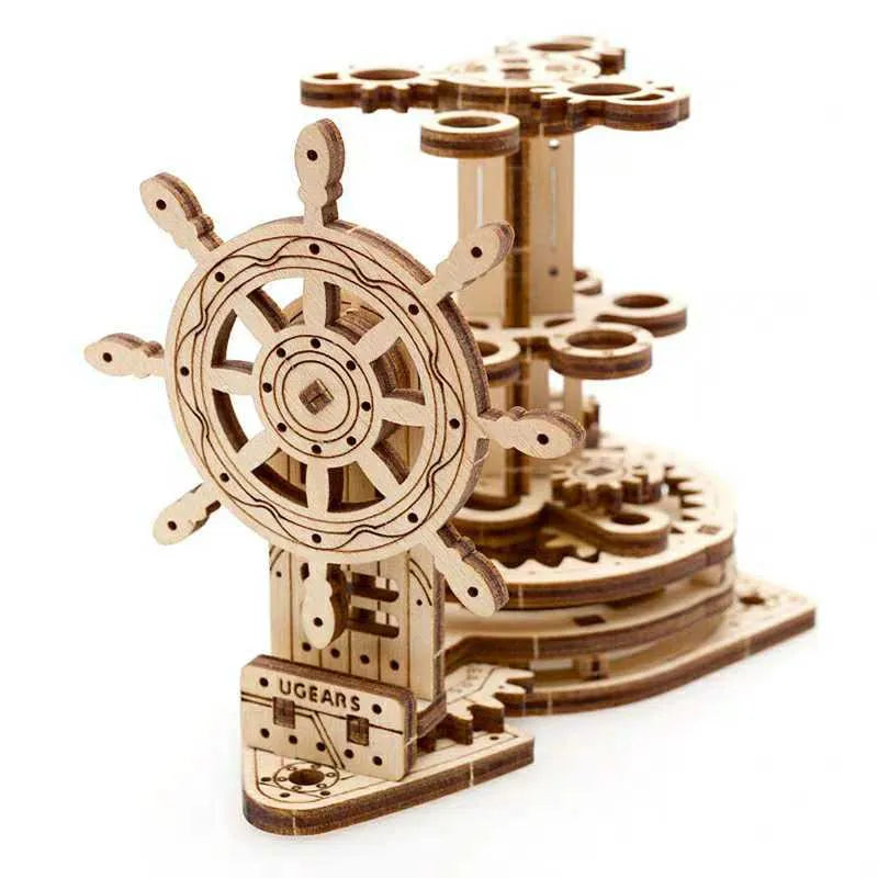 Wooden steering wheel model that rotates and functions as a pen holder on a desk.