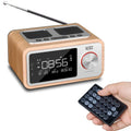 Compact wooden Bluetooth speaker alarm clock radio in golden oil colour on a desk