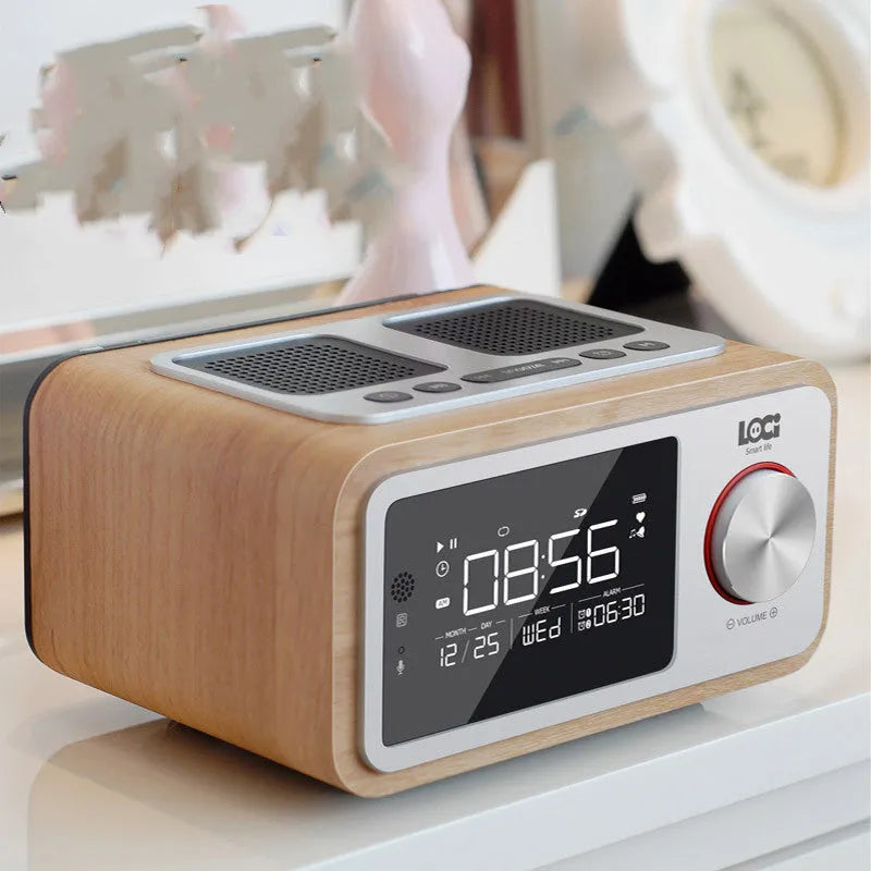 Compact wooden Bluetooth speaker alarm clock radio in golden oil colour on a desk
