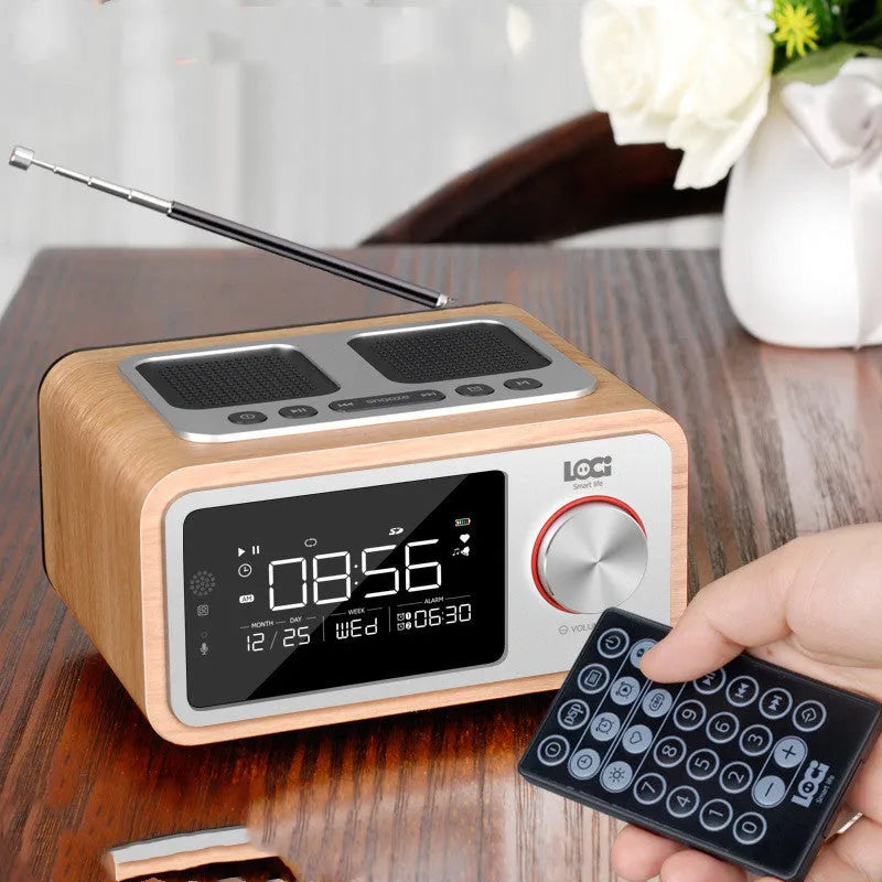Compact wooden Bluetooth speaker alarm clock radio in golden oil colour on a desk