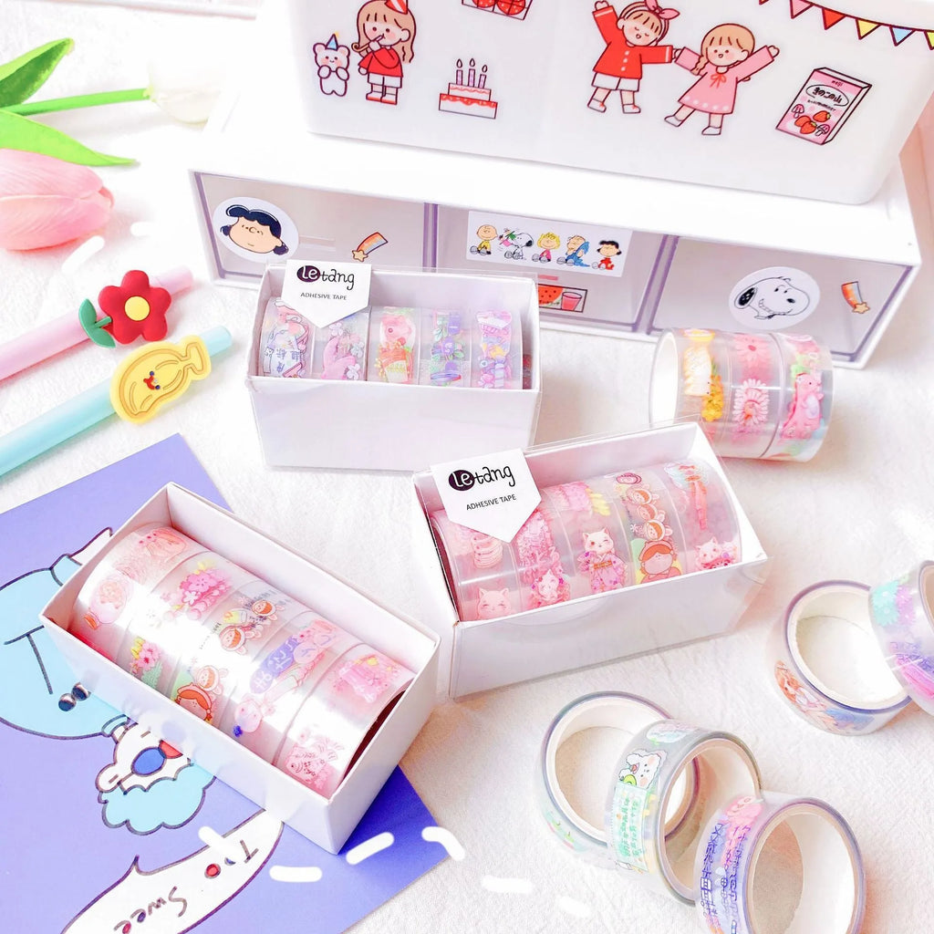 Five rolls of colourful washi paper sticker tape with cartoon designs of dinosaurs, ducks, cats, girls, and rabbits.