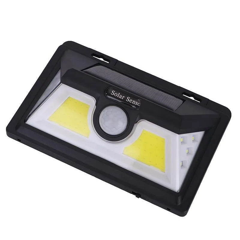 Solar-powered outdoor garden lamp with LED lights and integrated solar panel on a stake.