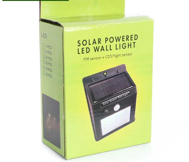 Solar-powered outdoor garden lamp with LED lights and integrated solar panel on a stake.