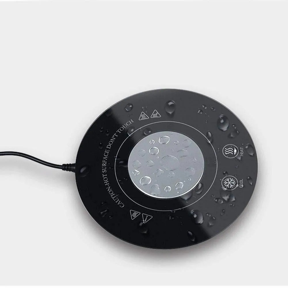 Black USB-powered hot and cold coaster for cans and cups on a wooden desk.