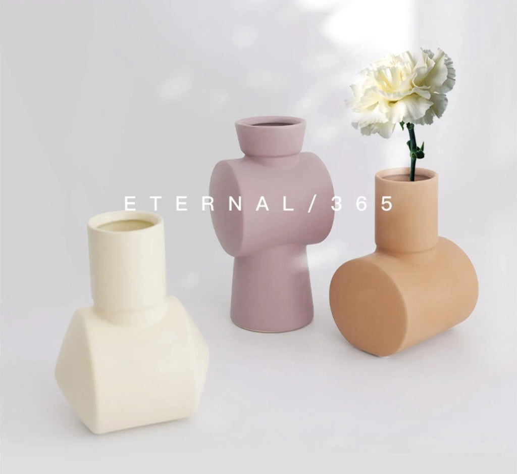 A beige, brown, or purple ceramic vase with a hammered glaze texture on a surface.