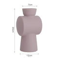 A beige, brown, or purple ceramic vase with a hammered glaze texture on a surface.