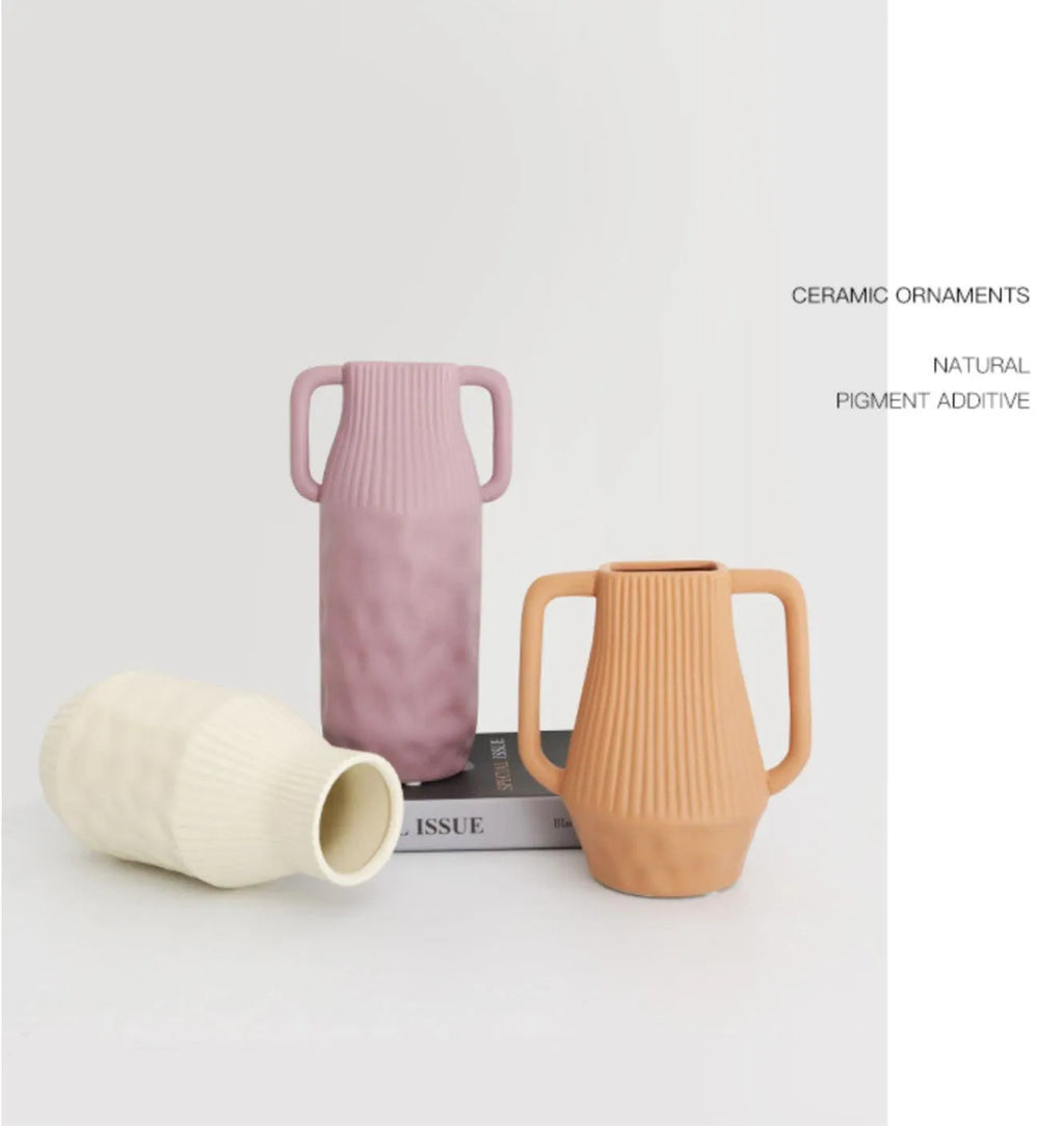 A beige, brown, or purple ceramic vase with a hammered glaze texture on a surface.