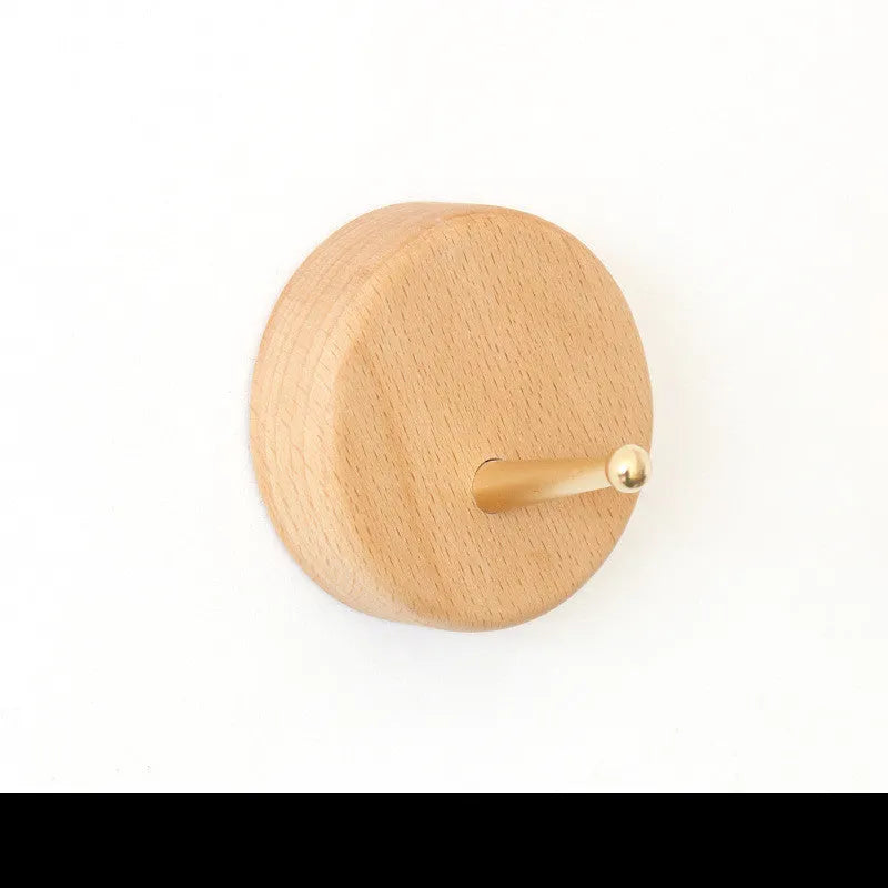 Beech wood adhesive wall hook in brass finish with 10kg capacity and geometric shape options