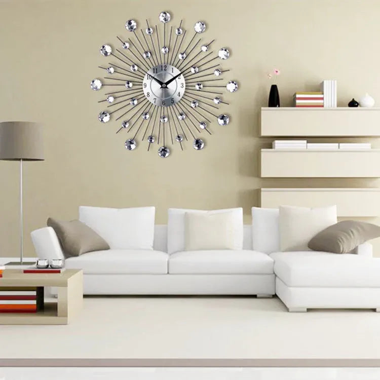 Large round silver mute wall clock with metal frame and numbered dial on a wall.