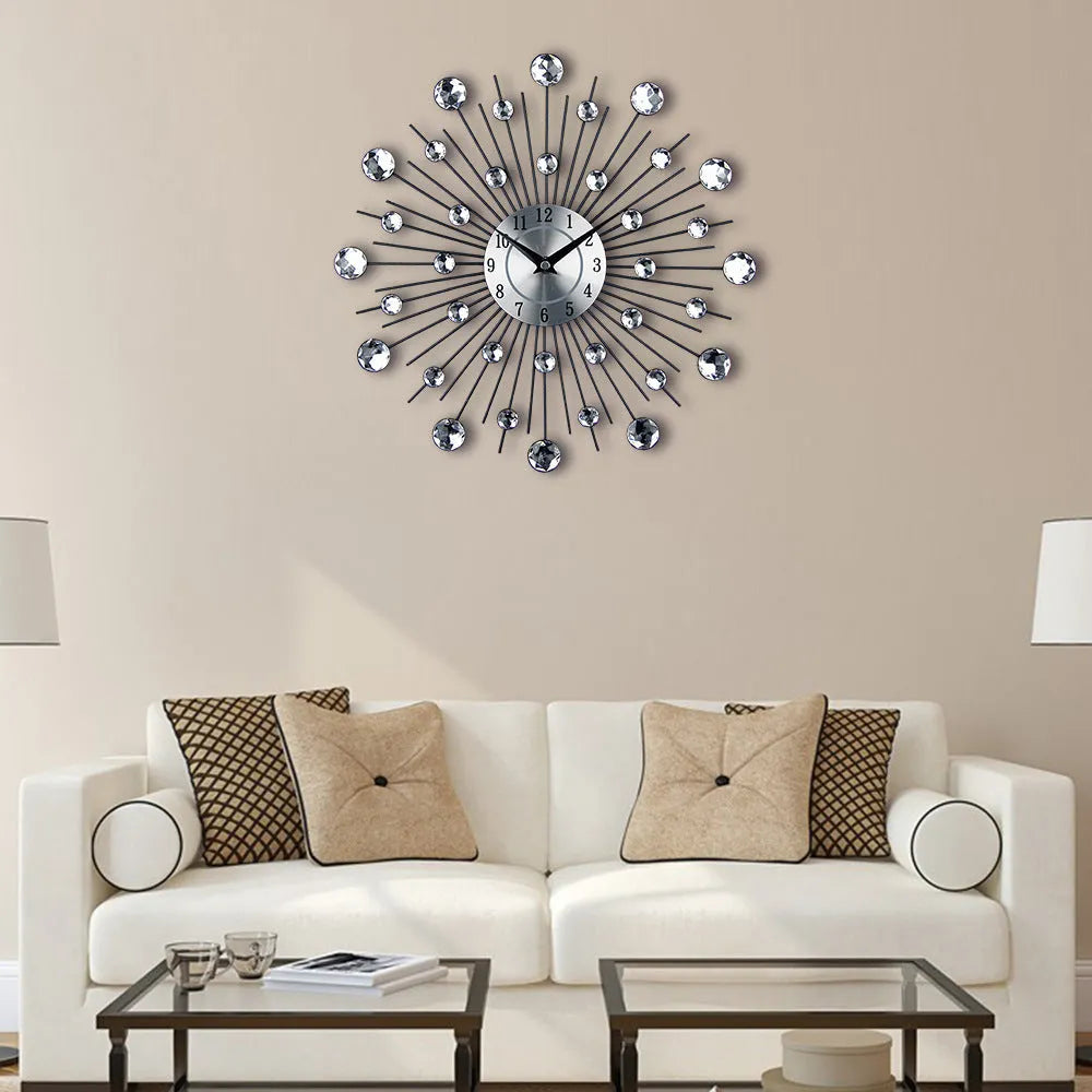 Large round silver mute wall clock with metal frame and numbered dial on a wall.