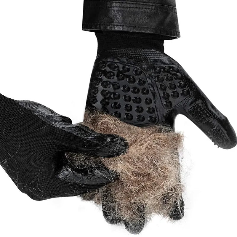 Pet hair grooming glove in black rubber with adjustable wrist strap on a light background