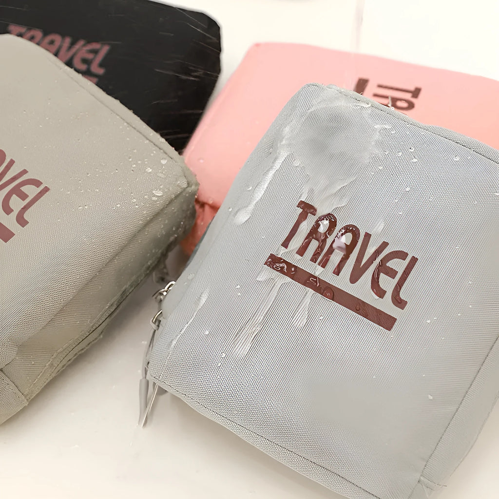 Black cube-shaped oxygen travel storage bag with a seal, shown next to a grey and a pink version.