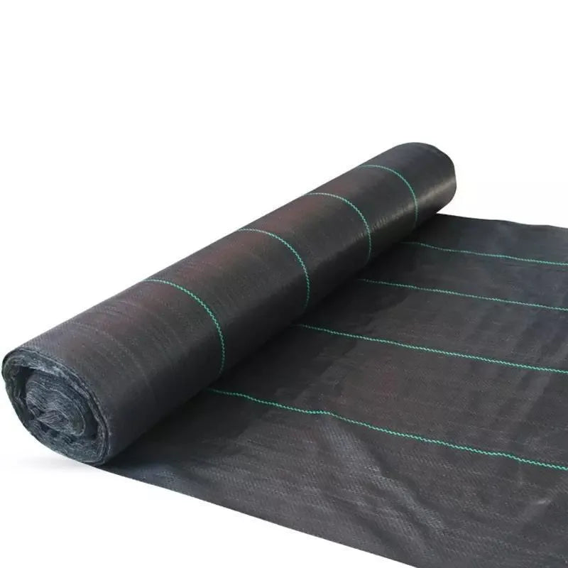 Black polyethylene weed-proof ground cover cloth laid flat on soil, showing woven texture.