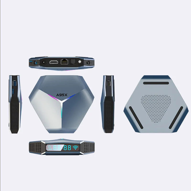 Black 8K Android TV set-top box with remote control and international power plugs on a wooden surface