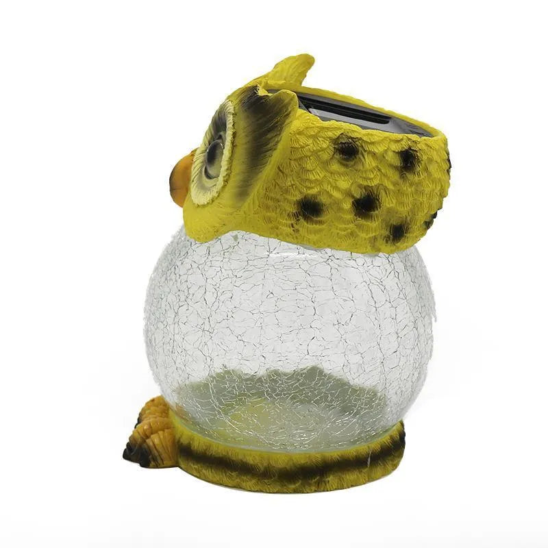 White solar owl garden light with realistic detailing and LED illumination for outdoor placement