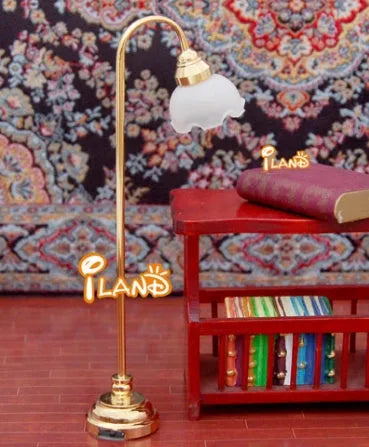 Dollhouse miniature LED floor lamp with glass shade and metal base on a white background.