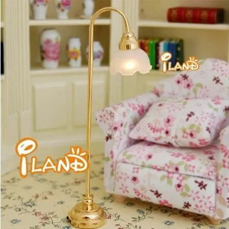 Dollhouse miniature LED floor lamp with glass shade and metal base on a white background.