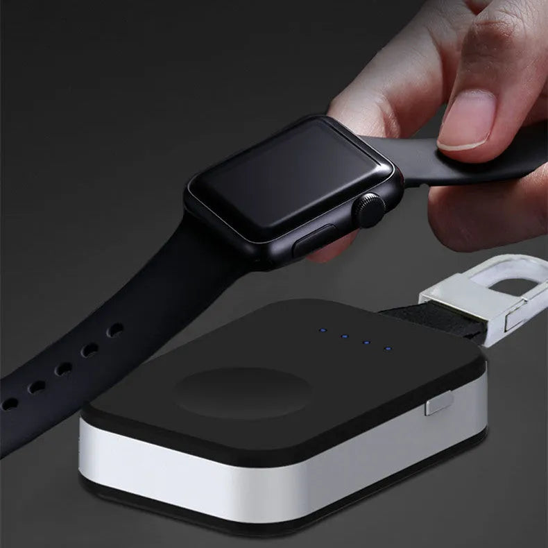 Black keychain-sized wireless power bank for Apple Watch on a keyring.