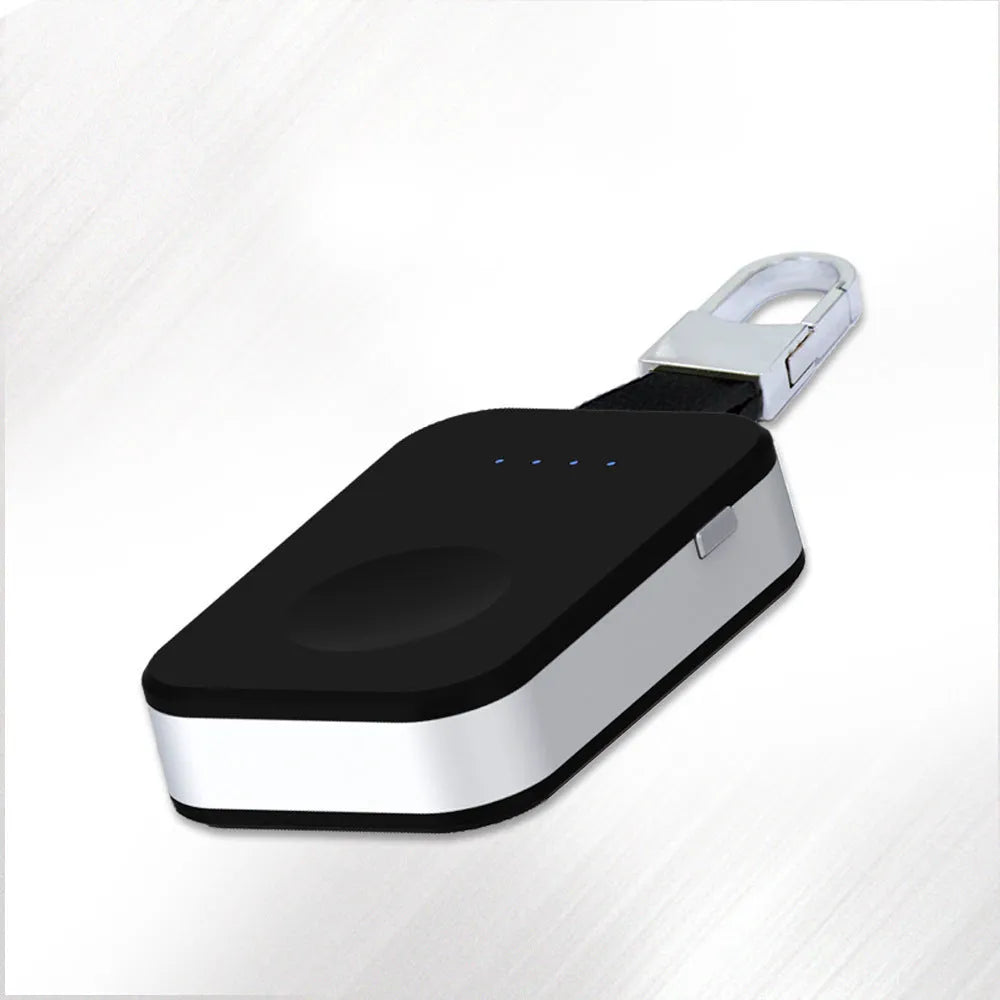 Black keychain-sized wireless power bank for Apple Watch on a keyring.