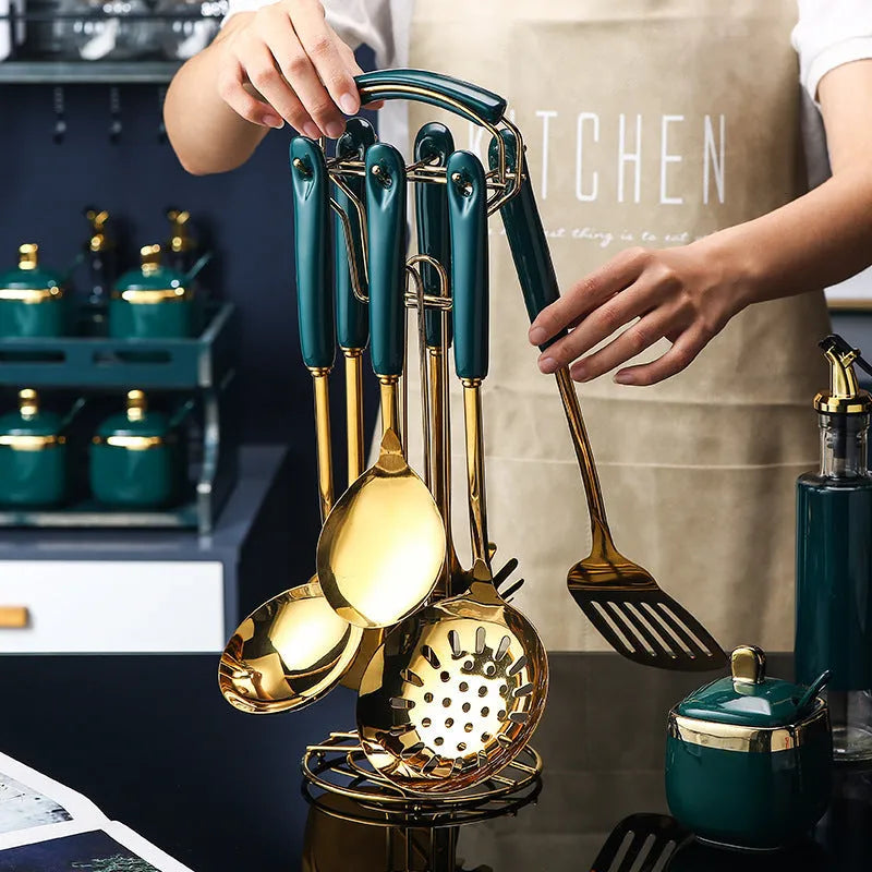 Seven-piece stainless steel and silicone kitchen utensil set including slotted spatula, turner, ladle, serving spoon, and pasta server.