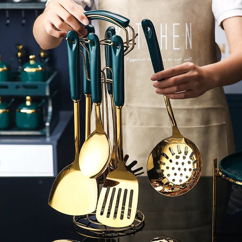 Seven-piece stainless steel and silicone kitchen utensil set including slotted spatula, turner, ladle, serving spoon, and pasta server.