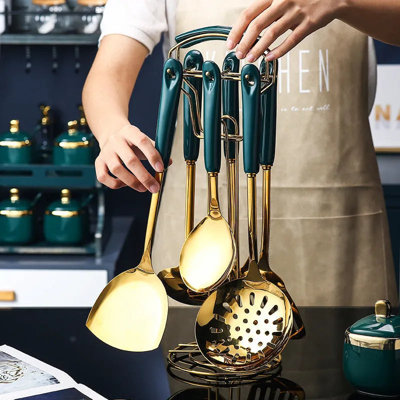 Seven-piece stainless steel and silicone kitchen utensil set including slotted spatula, turner, ladle, serving spoon, and pasta server.