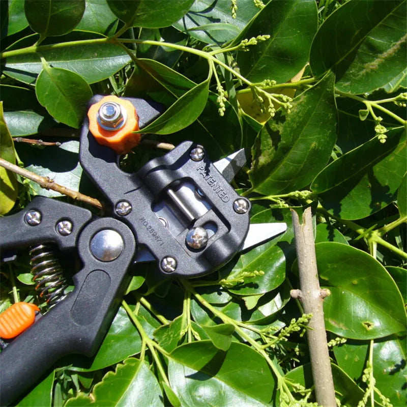 Black handheld grafting scissors with high carbon steel blade, open position showing U-shape cutting slot