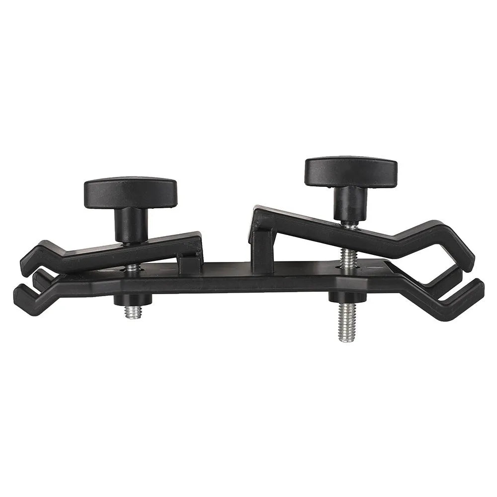 Black ABS plastic umbrella clip attached to an Apple tripod for camera rain protection.