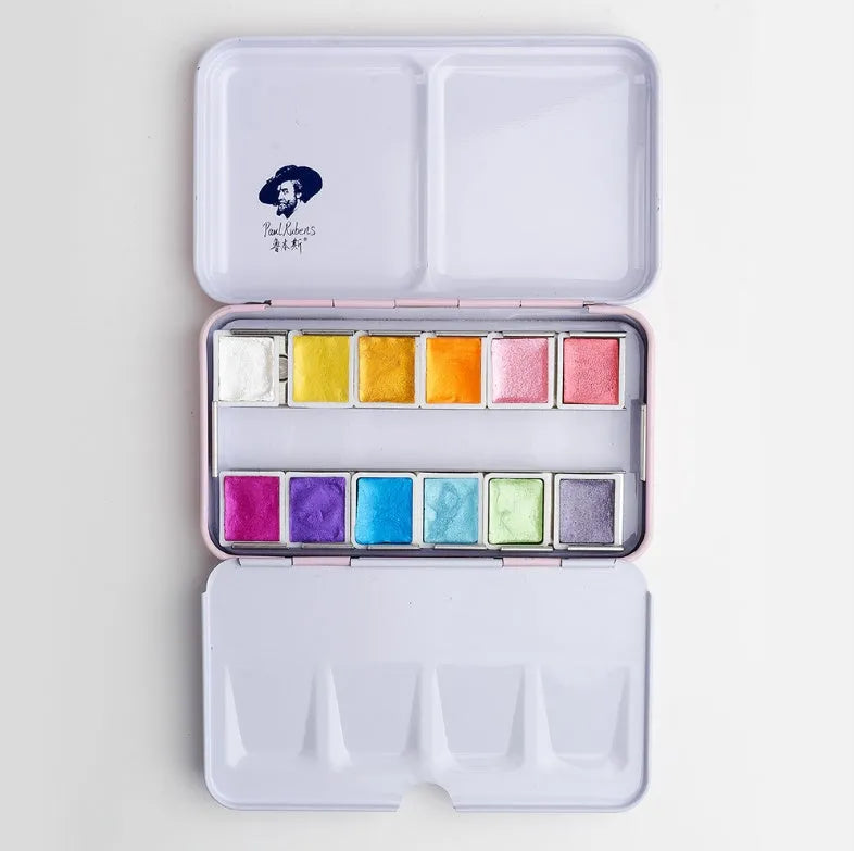 Pearl-effect solid watercolour paint pans in a set showing iridescent colours.