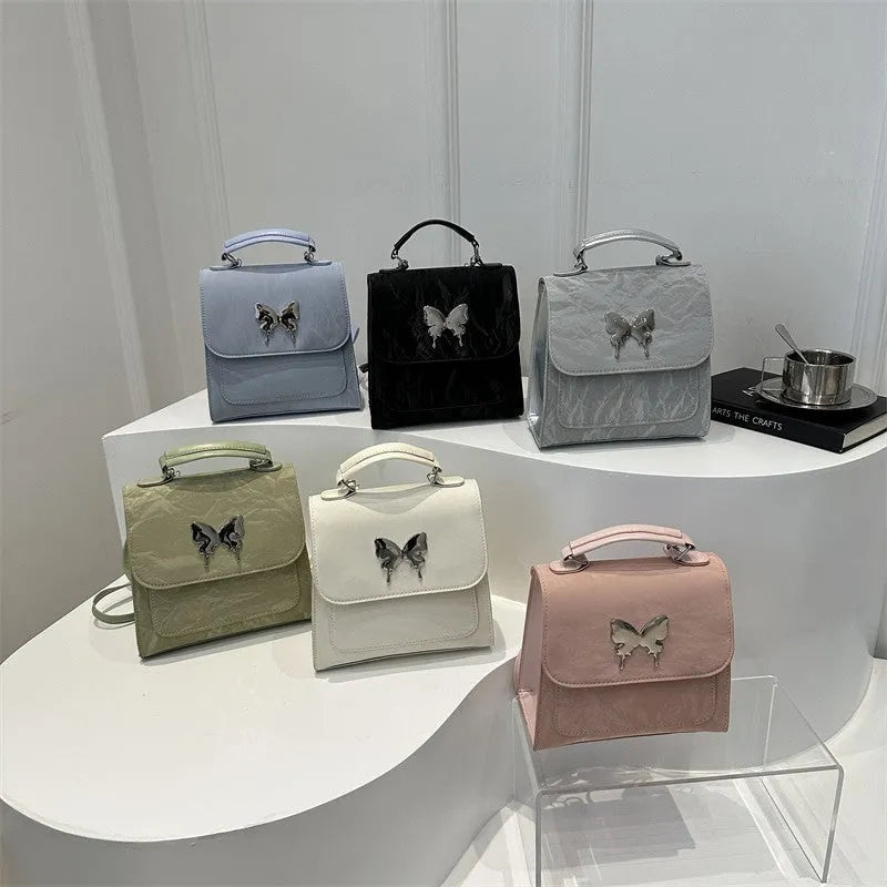 Women's preppy style PU backpack with hand-carry handle showing bow decoration and six colour options
