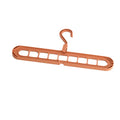 Green plastic multifunctional hanger with nine holes for trousers in a seamless folding pant rack design.