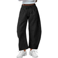 Loose fit cropped sweatpants in apricot colour with drawstring waist and side pockets on a neutral background.
