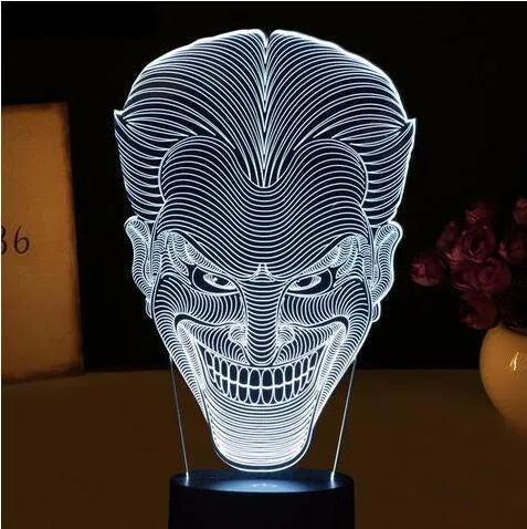 USB-powered 3D acrylic LED table lamp with remote control on a desk, displaying colourful gradient lighting.