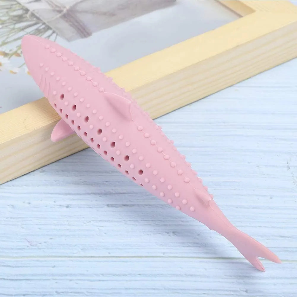Green dolphin-shaped silicone cat chew toy with side holes on a white background