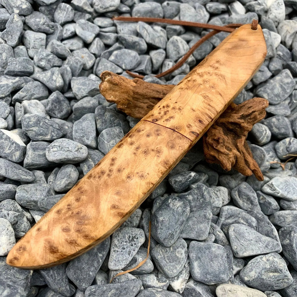 White Shadow Damascus steel short knife with Thuja wood handle, showing blade pattern.