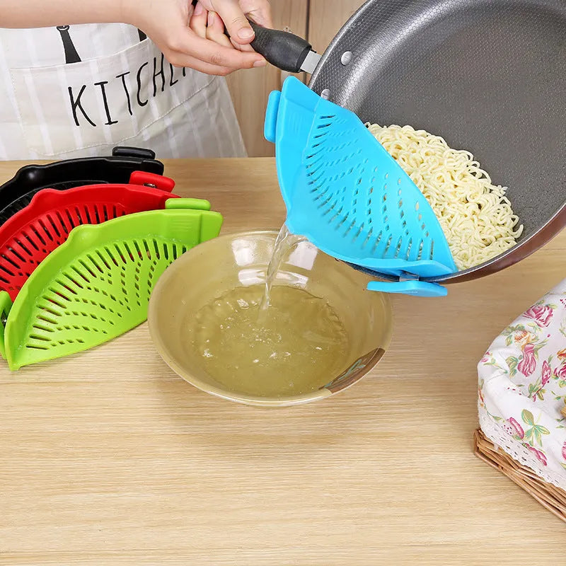 Silicone clip-on kitchen strainer with stainless steel frame attached to pot rim for draining liquids