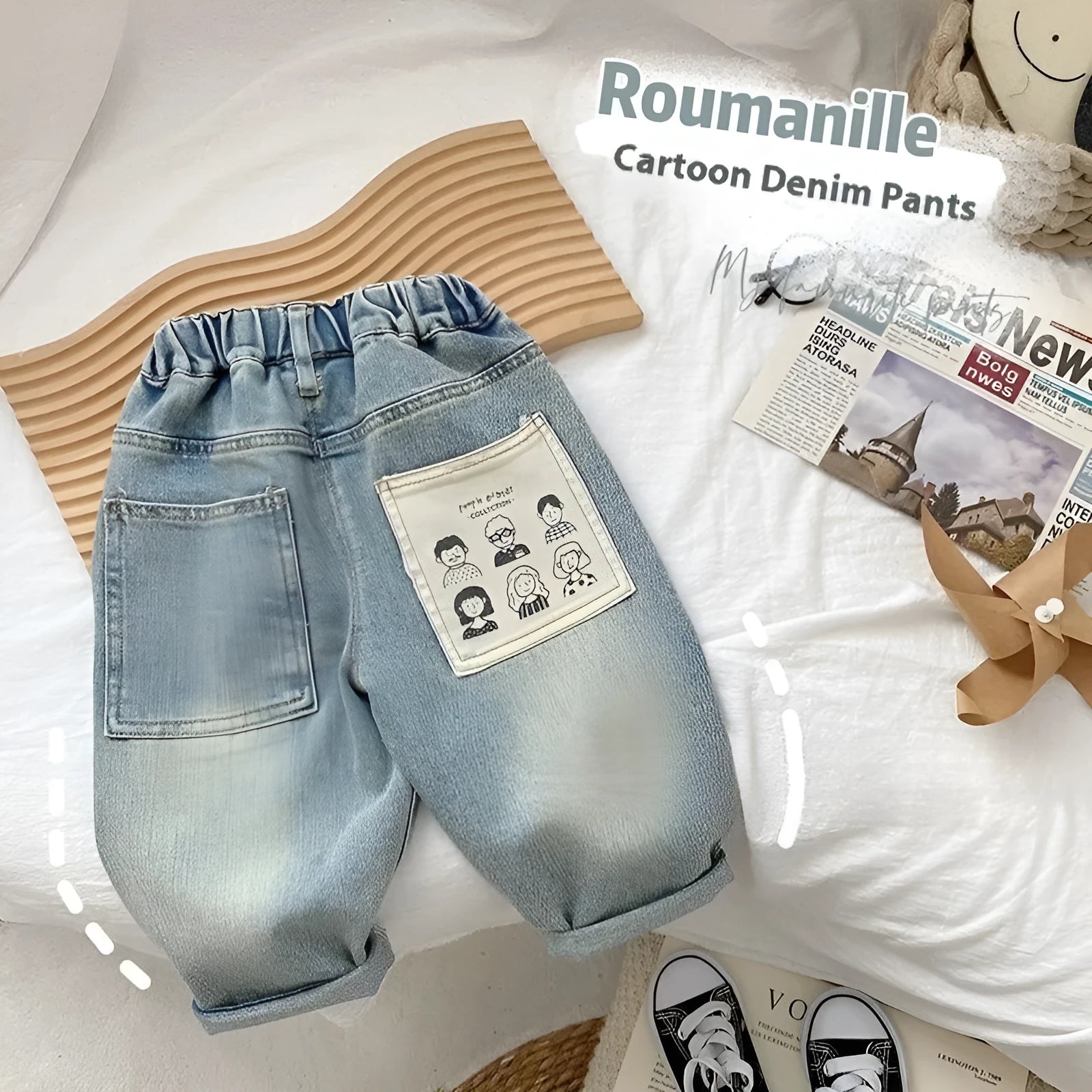 Light-coloured boys denim jeans with printed back pocket and elastic waist, front view