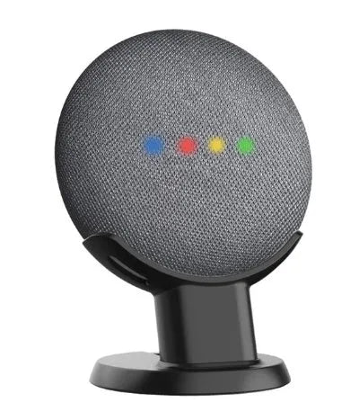Black plastic Google Home Mini stand holder on a wooden desk