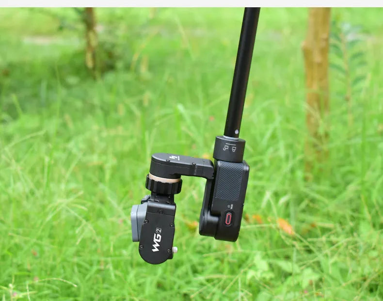 Black retractable selfie stick extended to full length with a smartphone attached, showcasing its hand-held stabiliser grip.