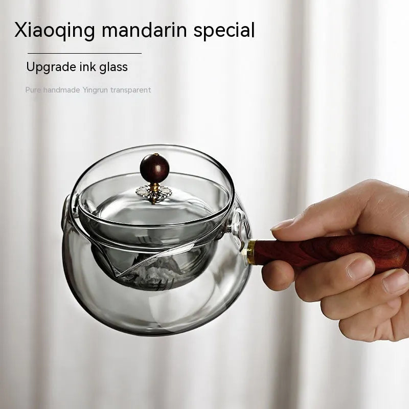 Rotating glass teapot with wooden handle and stainless steel infuser basket