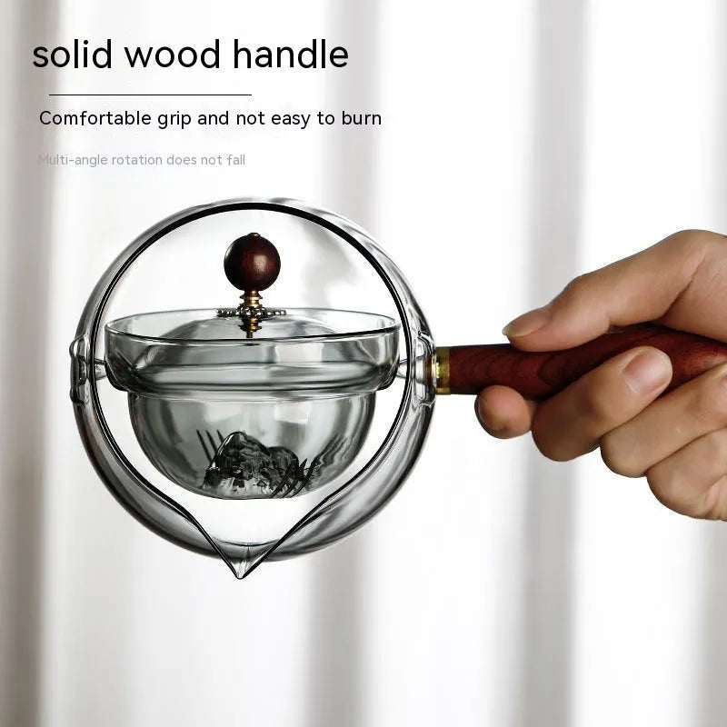 Rotating glass teapot with wooden handle and stainless steel infuser basket