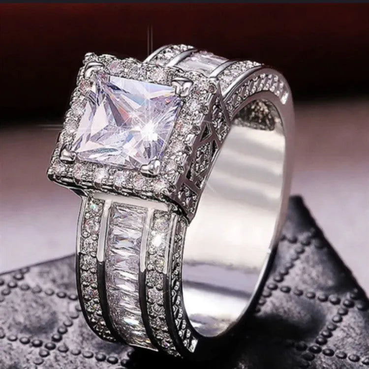Geometric round women's alloy ring in gold or white electroplated finish.