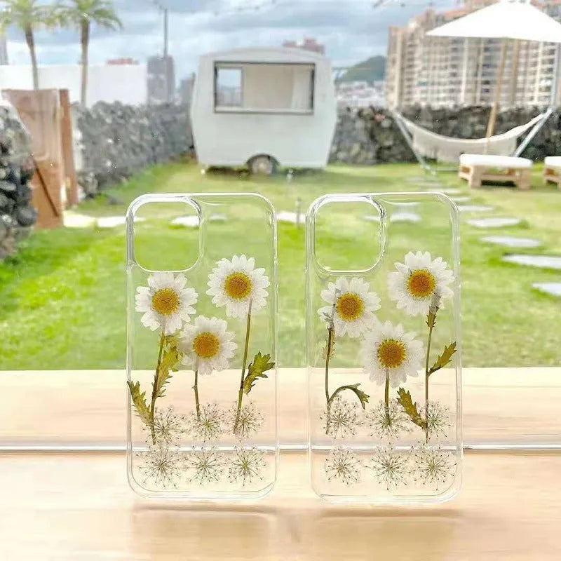 White epoxy daisy floral design on a clear TPU protective phone case for iPhone.