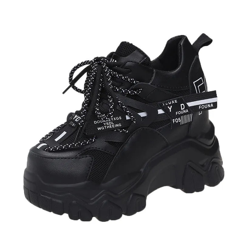 White and black women's low-top platform sports shoes with a cross strap and mesh upper.