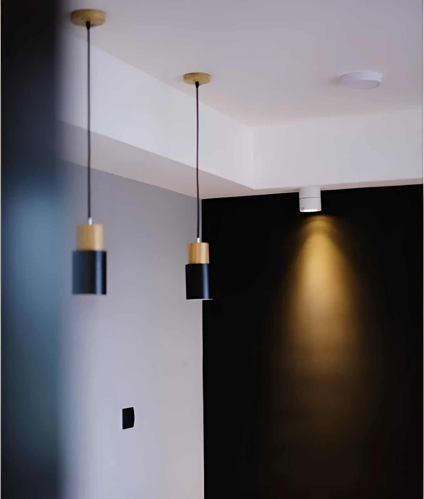Nordic style solid wood and iron pendant light hanging above a kitchen counter.