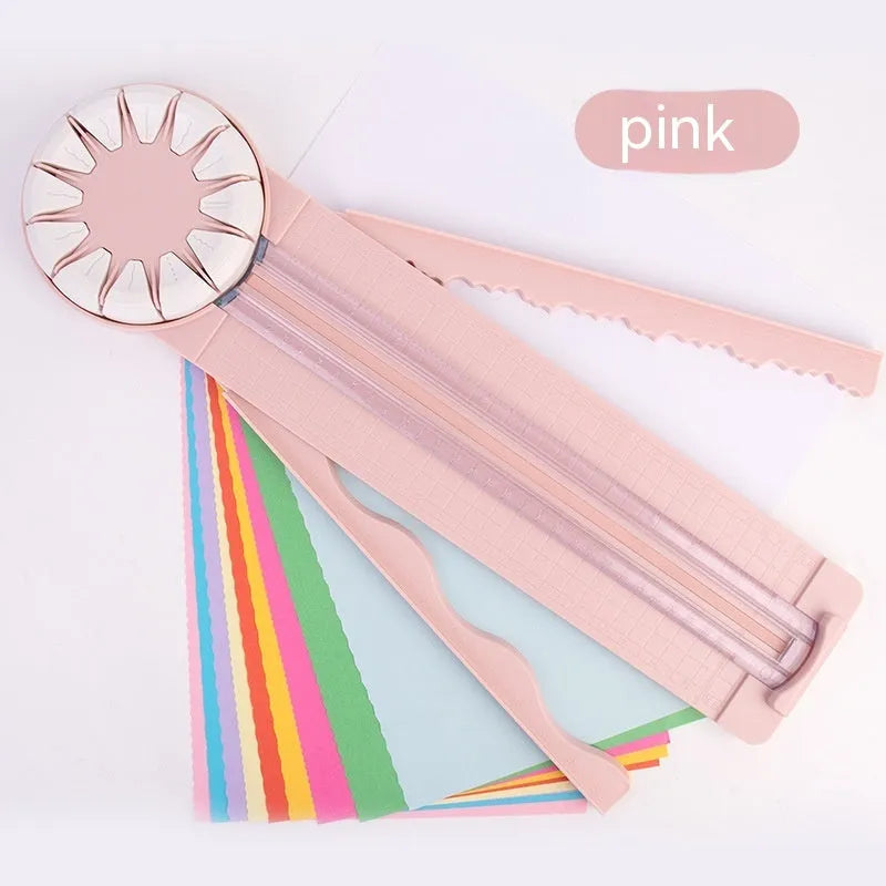 Pink and black 12-in-1 multifunctional plastic paper cutting machine on a white background.