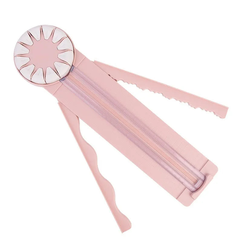 Pink and black 12-in-1 multifunctional plastic paper cutting machine on a white background.