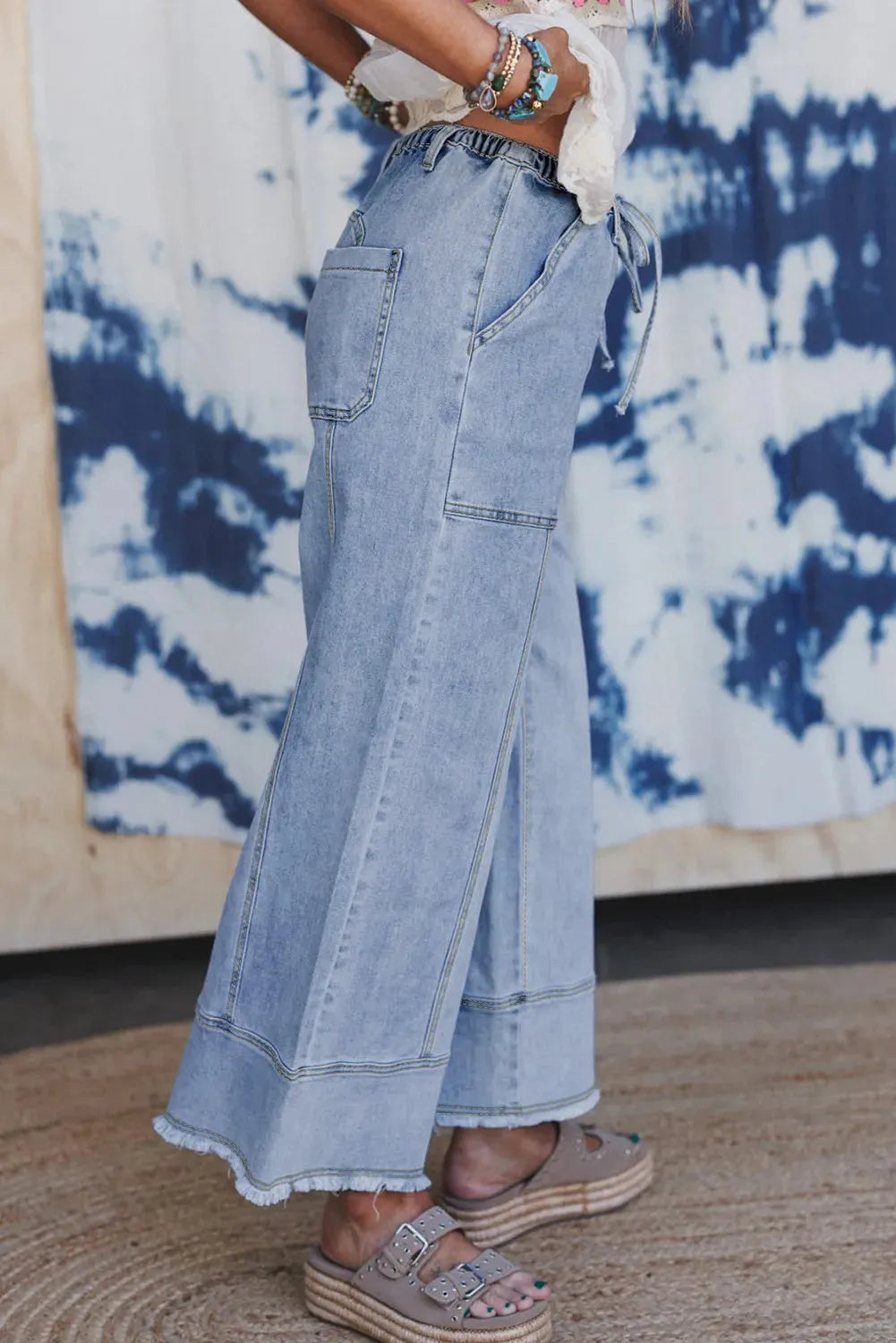 Beau blue wide leg denim trousers with drawstring seam detailing and raw hem finishing